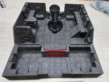Load image into Gallery viewer, A gray 3D-printed tabletop terrain piece depicting a sci-fi room or corridor, featuring a central green-lit cylindrical structure, a red door, and various modular walls and stairs, shown on a grid-patterned surface.