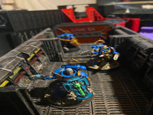 Load image into Gallery viewer, Three painted miniature figurines of Space Marine soldiers in blue armor with gold and green details, positioned inside a detailed gray plastic sci-fi corridor diorama.